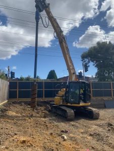 Plant Hire 15T Excavator Drilling hole with rock drill Auger